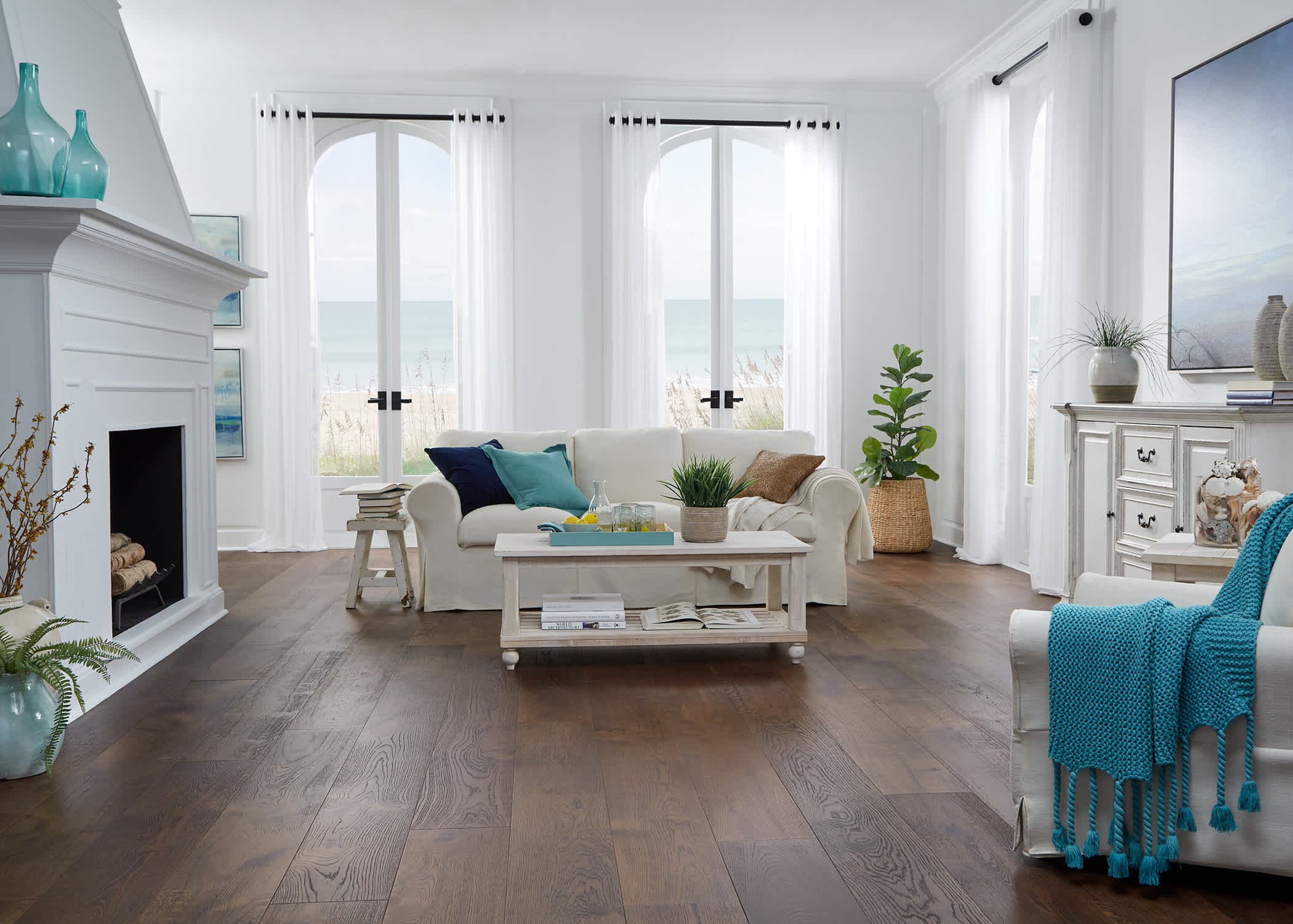 Rockaway Beach White Oak Distressed Engineered Hardwood Flooring in living room with white furniture and turquoise accents