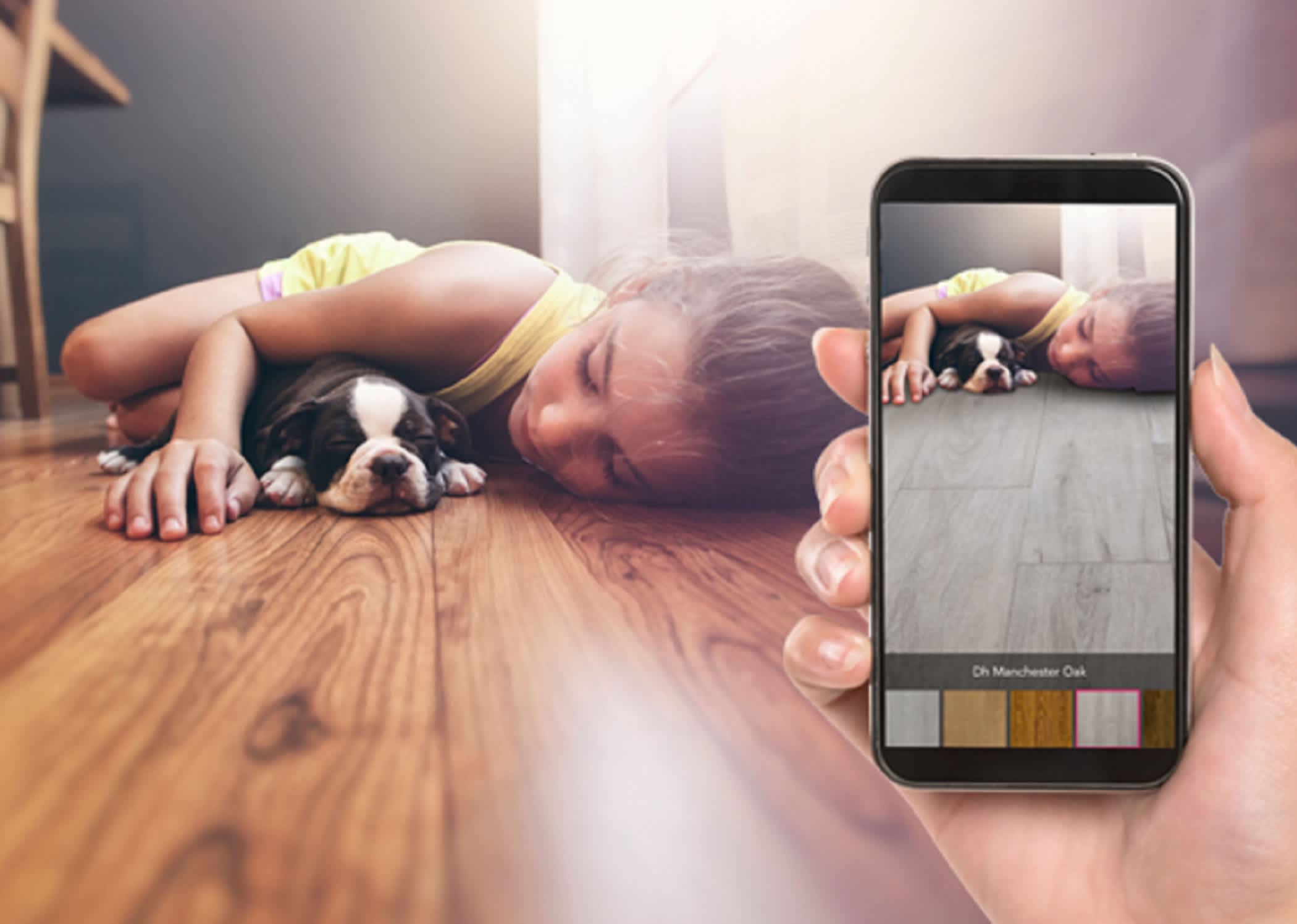 child laying on floor next to puppy plus hand holding cell phone