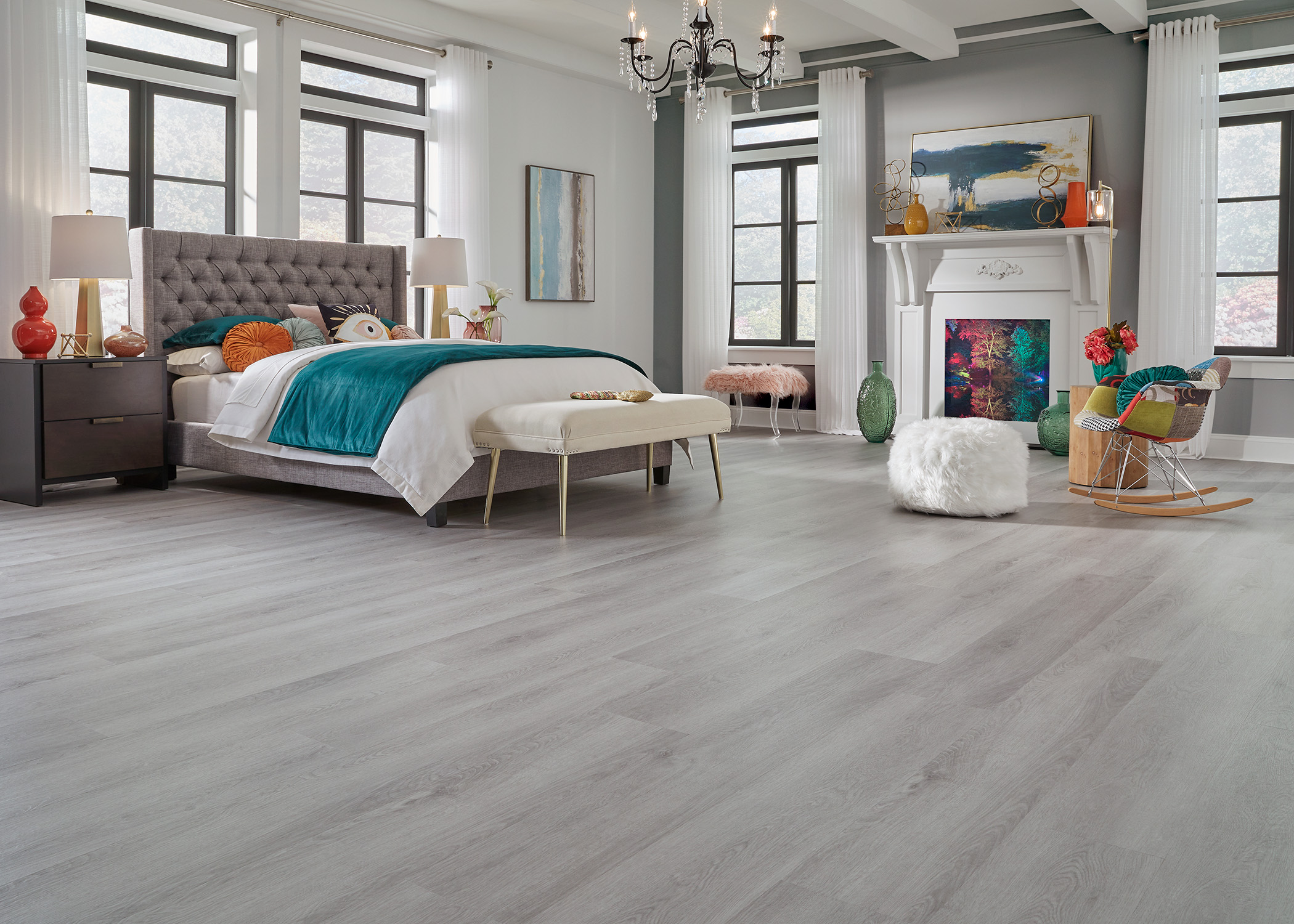 large bedroom with color accents and vinyl plank flooring