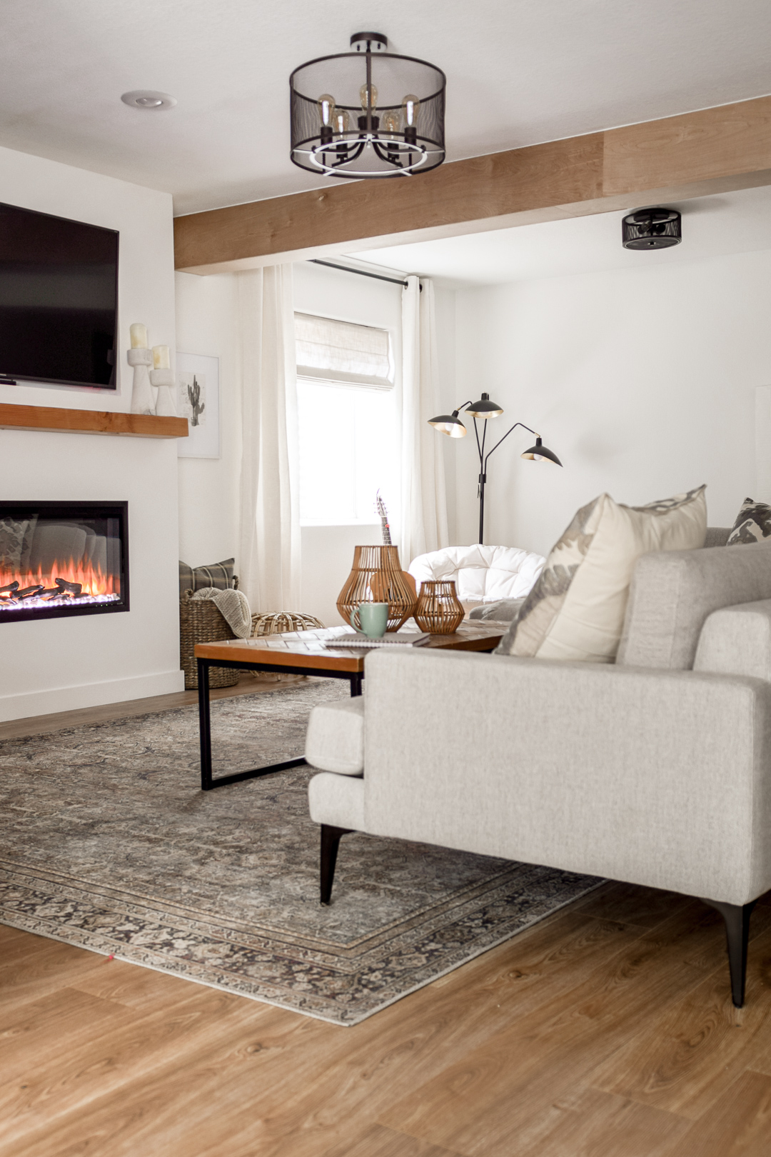 basement after remodel with hybrid resilient flooring and gas fireplace