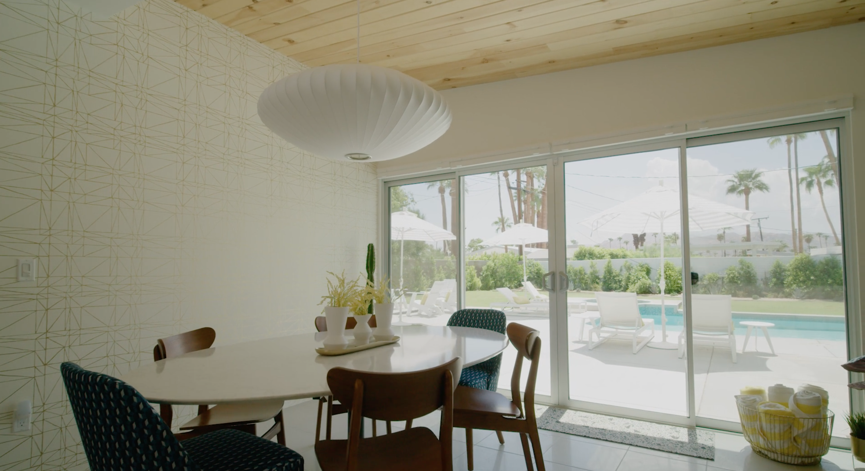 a dining room with view of swimming pool