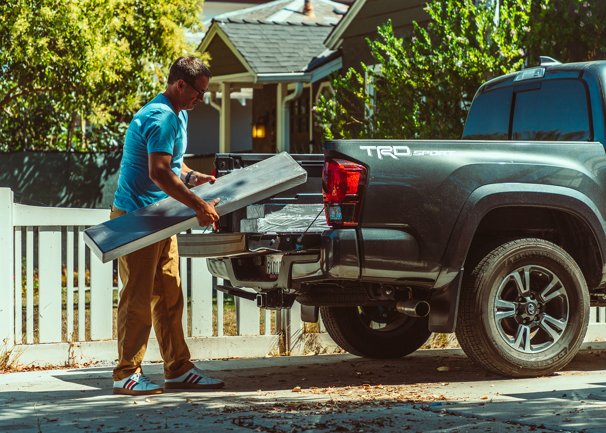 man unloads flooring planks from truck