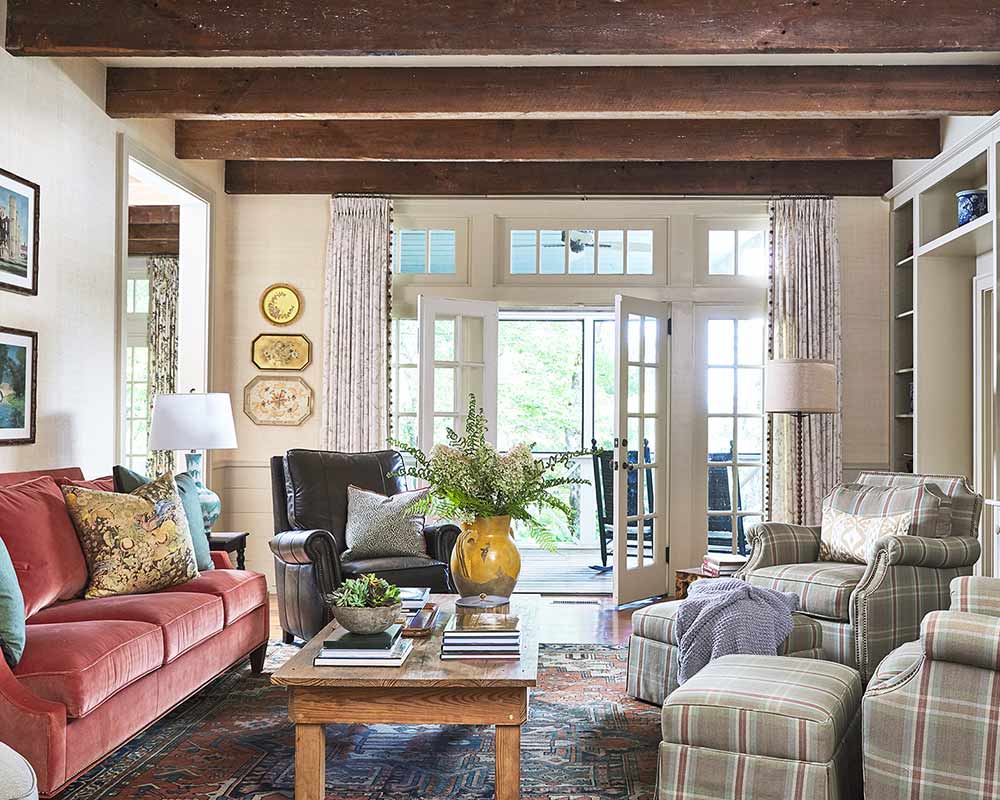 craftsman living room with red couch and hardwood flooring 