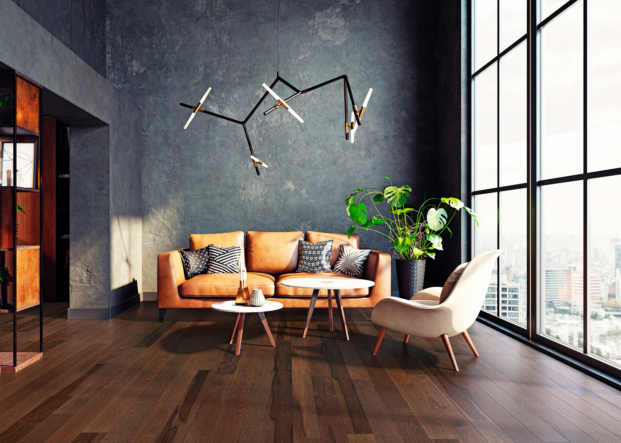 dark brown engineered hardwood floor in living room with dark gray plaster walls plus caramel leather sofa and cream accent chair