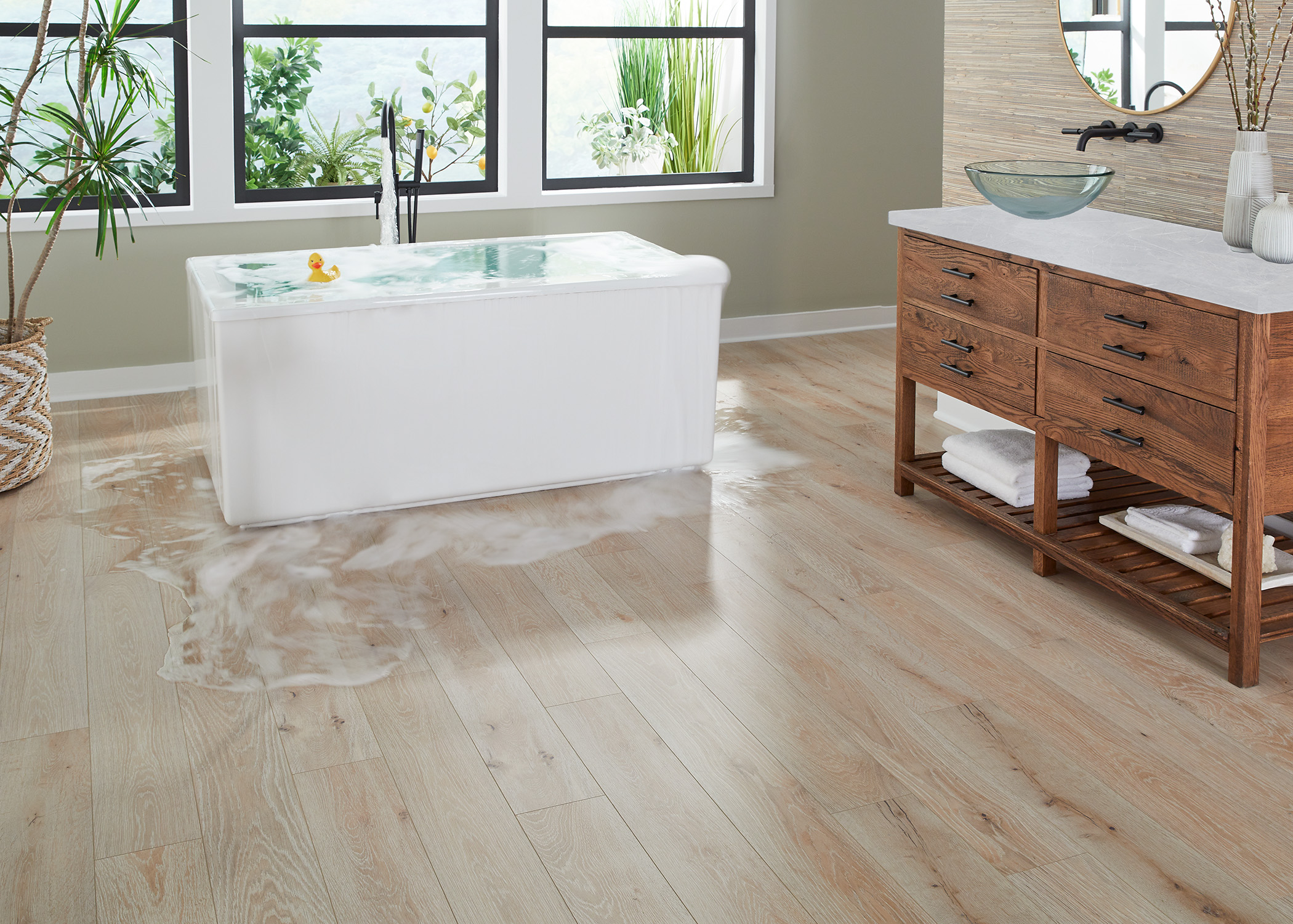 blonde with dark knots waterproof rigid vinyl plank  in bathroom with water overflowing from freestanding tub and vessel sink