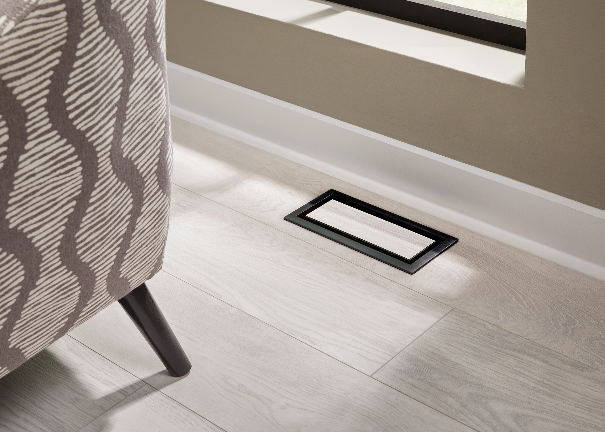 aria vent and white molding in waterproof laminate floor in basement family room