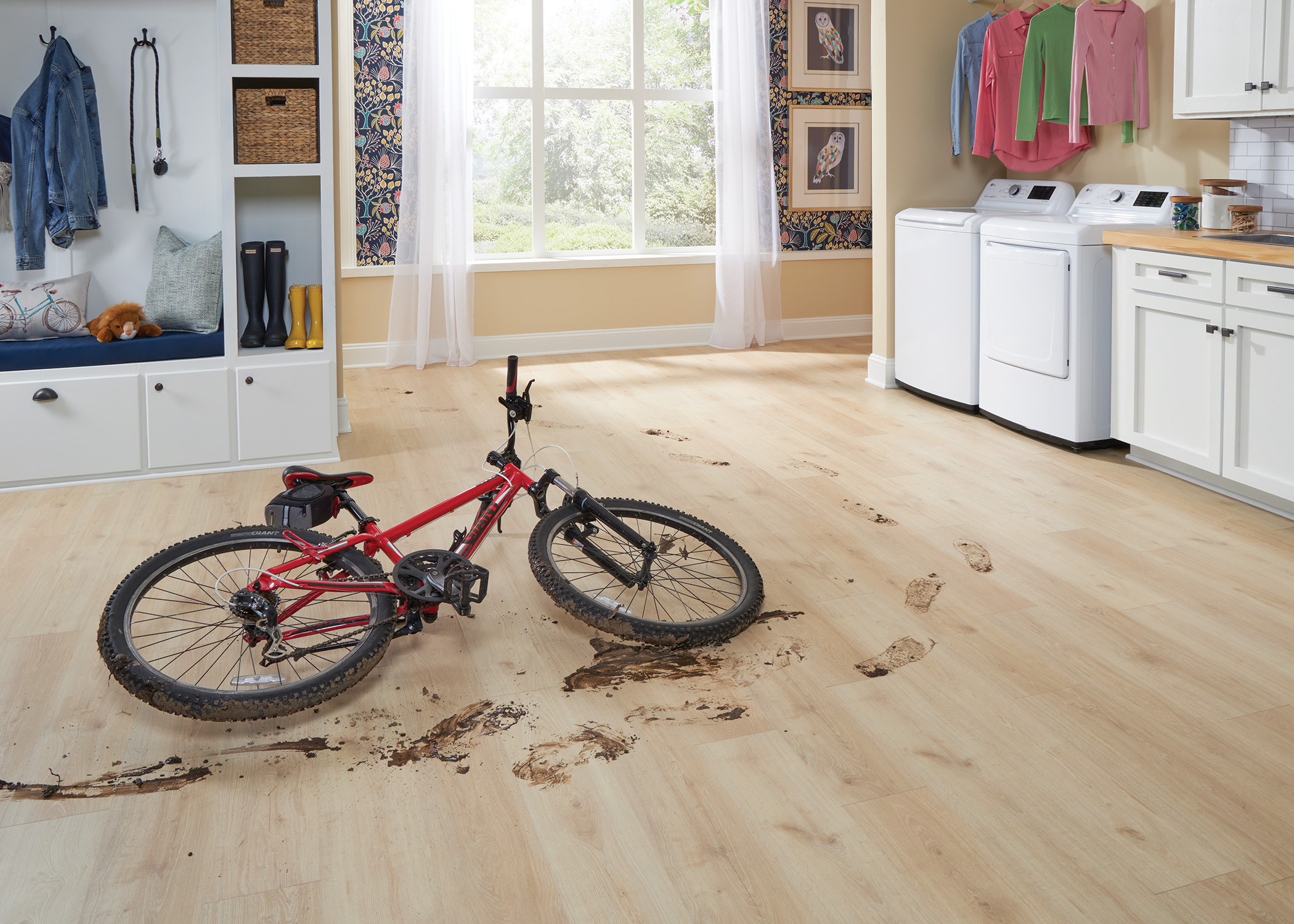 blonde waterproof hybrid resilient flooring closeup of muddy bike showing scratch-resistant floor