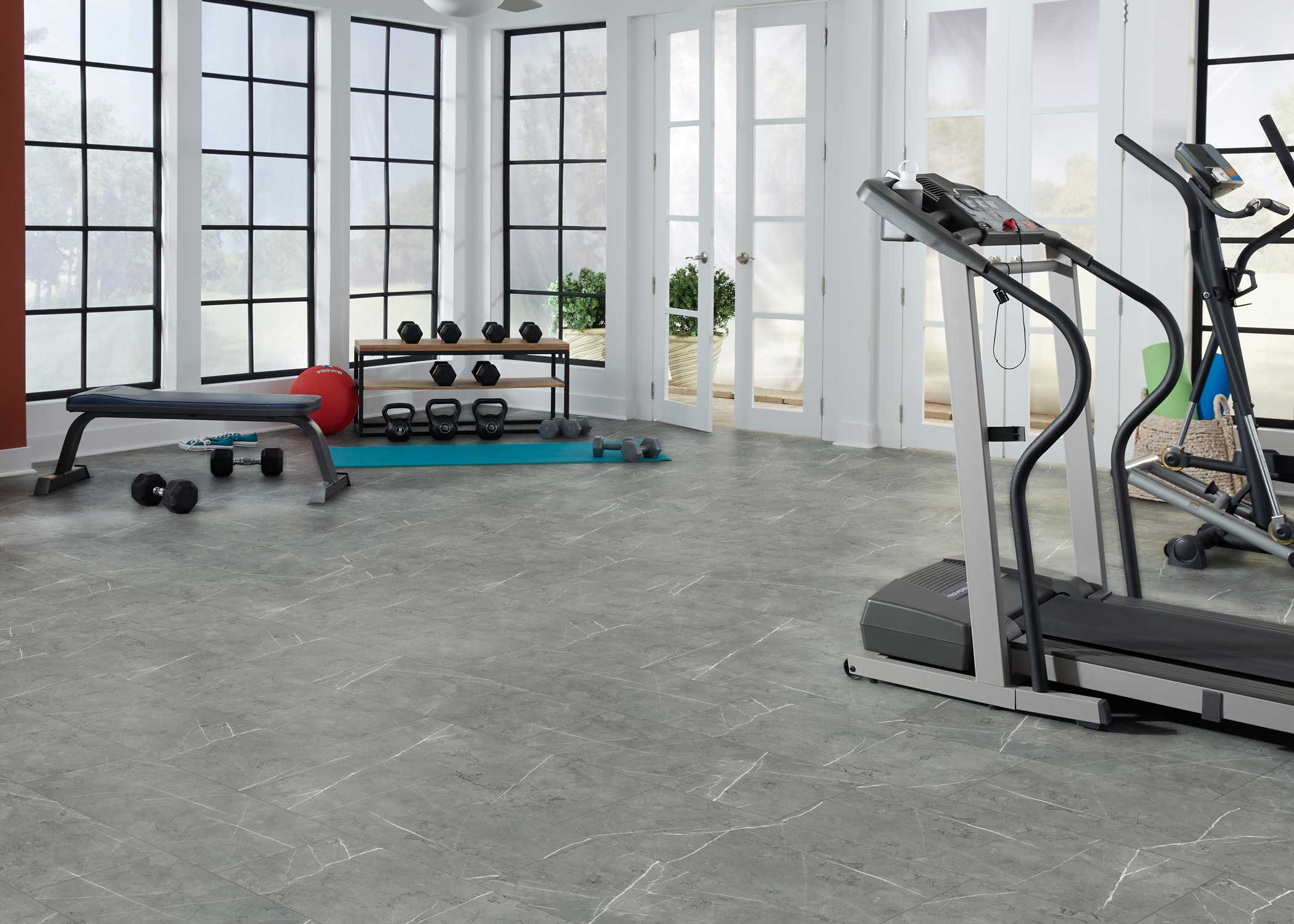 gray marble look vinyl tile flooring in home gym with treadmill plus elliptical and free weights