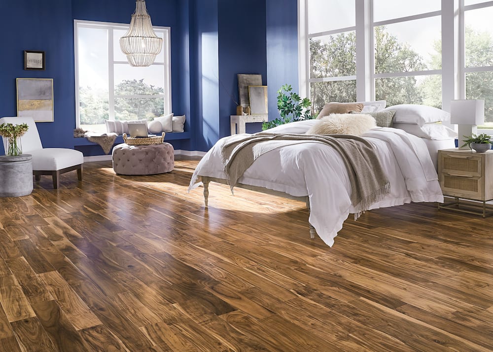 1/2 in. x 4.75 in. Acacia Quick Click Engineered Hardwood Flooring in bedroom with dark blue walls plus beaded chandelier and bed with white bedding