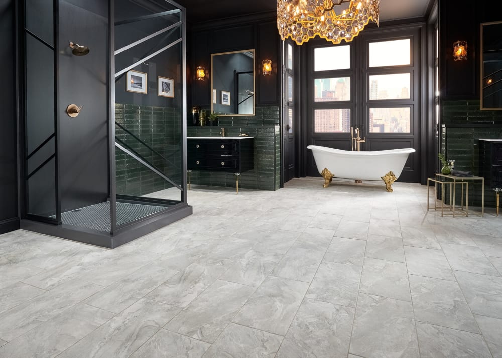 24 in. x 12 in. Castle Rock Porcelain Tile in bathroom with black freestanding shower plus black walls and gold chandelier