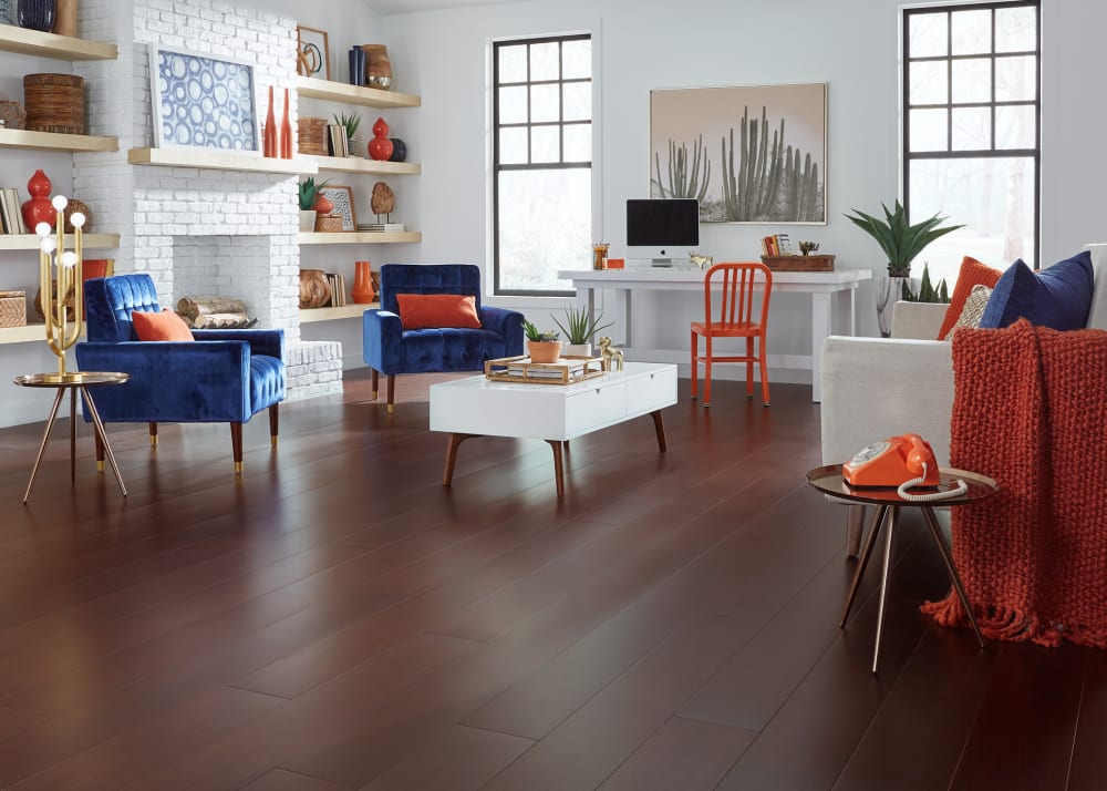 6mm x 7.5 in. Cabernet Extra Wide Plank Engineered Bamboo Flooring in living room with royal blue velvet chairs plus beige upholstered sofa with orange throw and white desk with orange metal chair