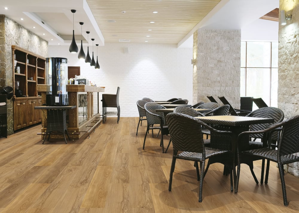 European Oak Cork Flooring in cafe setting with dark brown rattan chairs and square tables plus bar counter with sitting area and built in shelves
