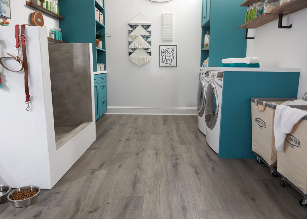 9mm with Pad Silk Spire Oak Waterproof Hybrid Resilient Flooring in laundry room with dog washing station plus turquoise cabinets and white washer and dryer