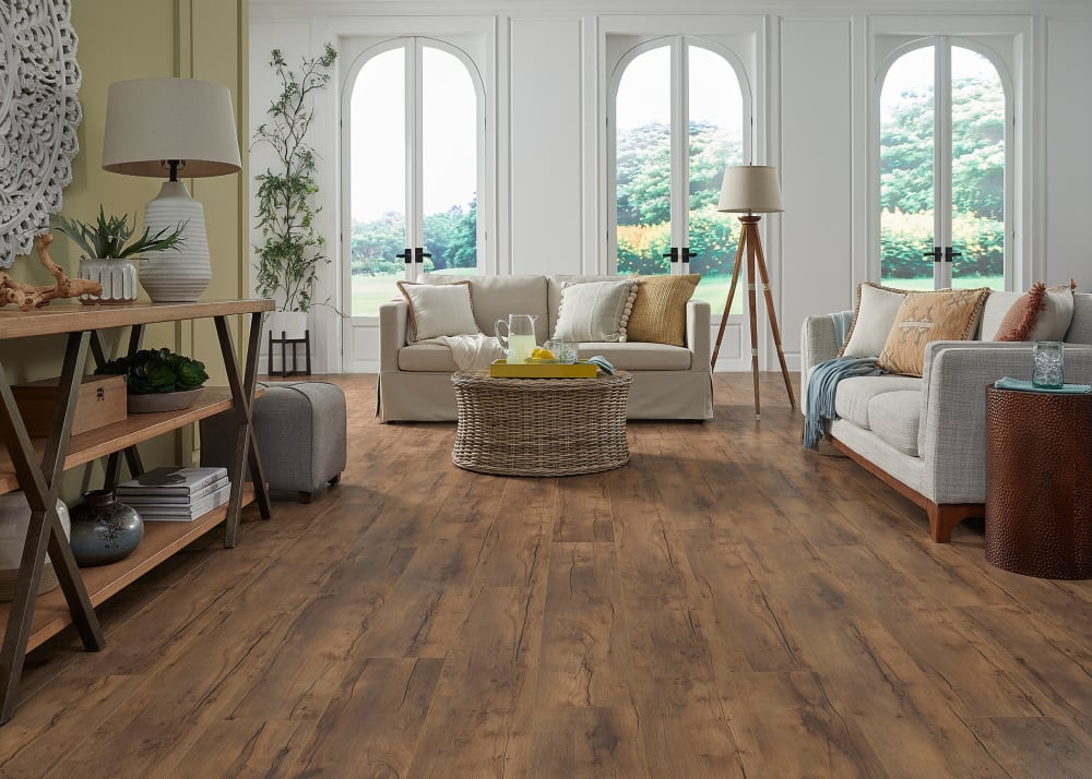 10mm+Pad Amber Crest Oak Waterproof Laminate Flooring in living room with pale green wall and beige colored sofas