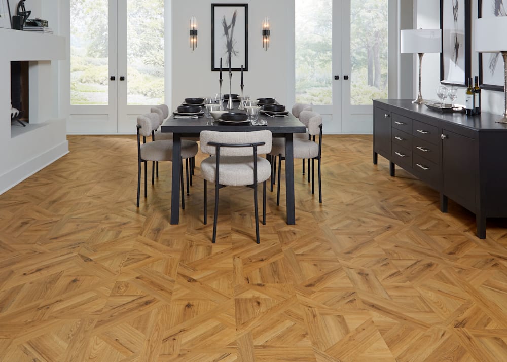 8mm Chapel Oak Waterproof Laminate Flooring in dining room with black dining table and credenza with cream armless dining chairs and black and white artwork