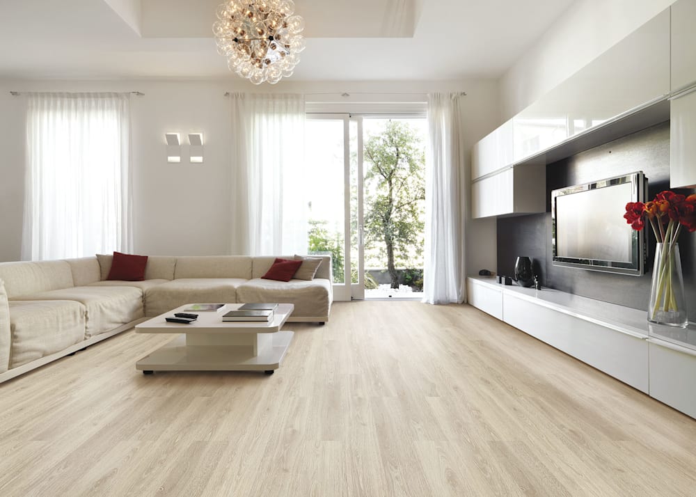 6mm x 7.67 in Alpine Oak Waterproof Cork Flooring in living room with off white sectional plus white cocktail table and white entertainment center