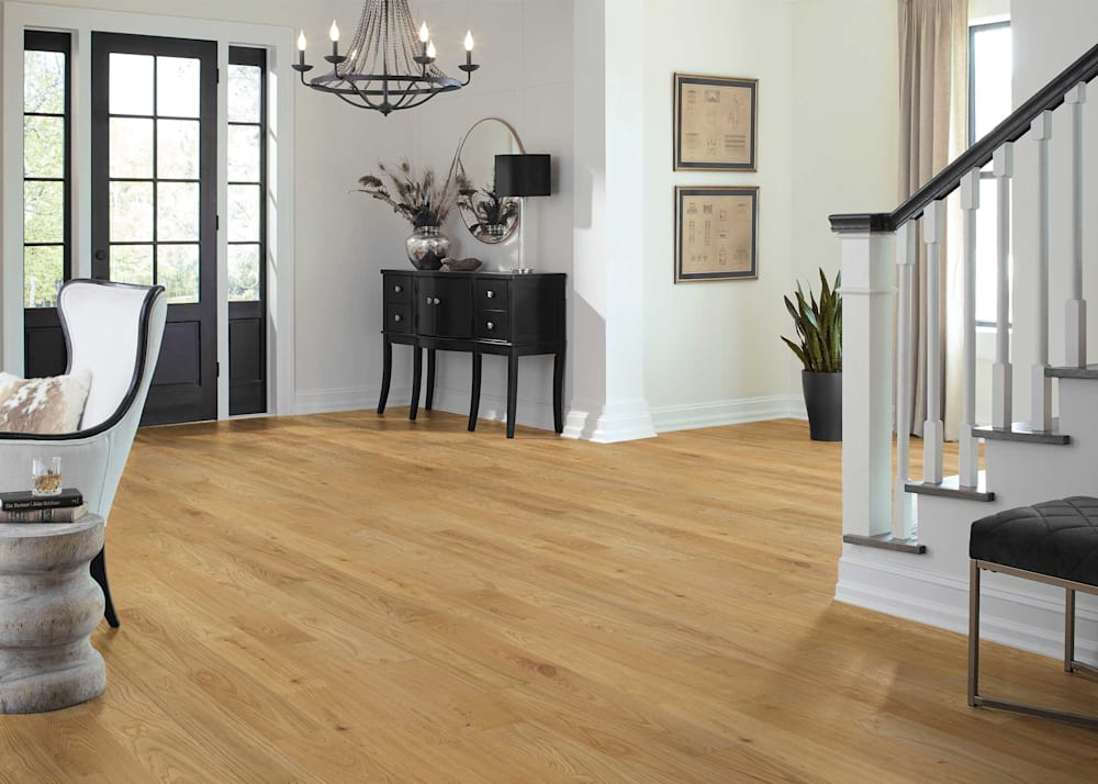 3/4 in x 4.8 in Lionheart Chestnut Distressed Solid Hardwood Flooring in entryway with black credenza and black chandelier plus off white walls and black front door