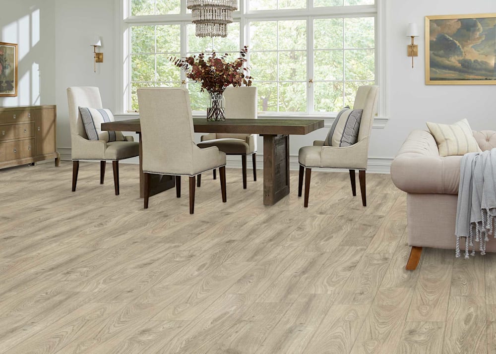 5mm with Pad Runway Oak Waterproof Rigid Vinyl Plank Flooring in dining room with dark brown dining table and beige upholstered wing back chairs plus beige upholstered sofa