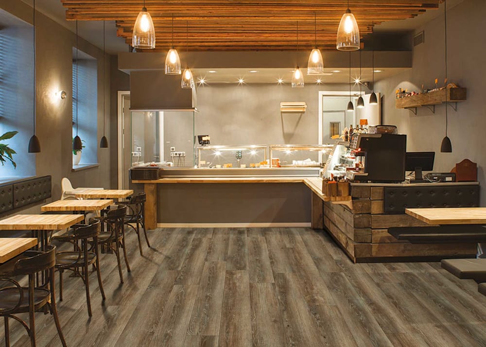 3mm Sparta Oak Waterproof Glue Down Rigid Vinyl Plank Flooring in restaurant with open kitchen and dining concept with butcher block dining tables and bench seating